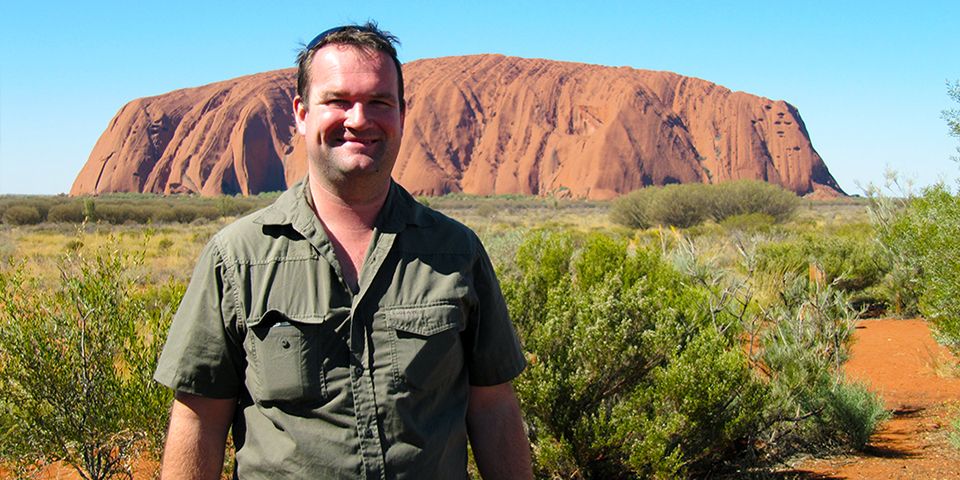 David Whitley with Uluru in the background