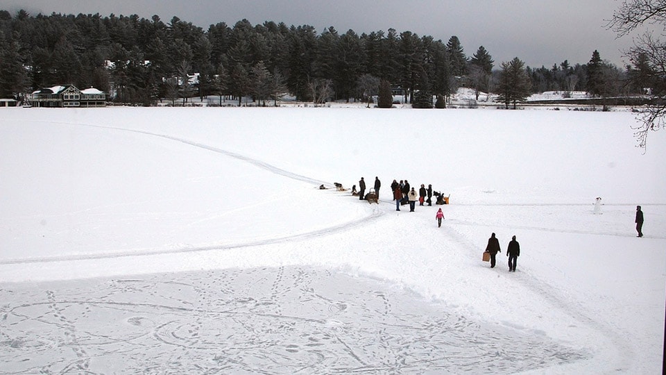 Lake Placid in New York frozen with people sledging across